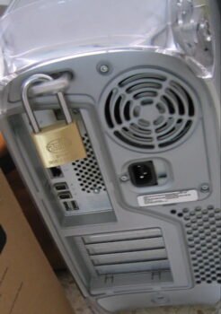 A computer secured with a physical padlock.