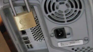 A computer secured with a physical padlock.